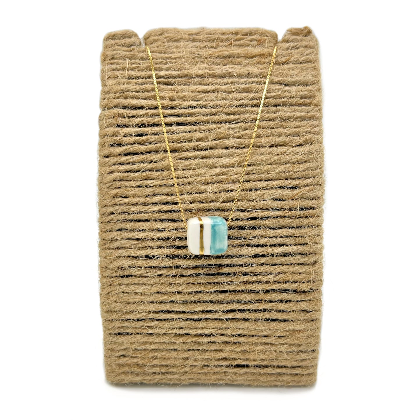 Pendant with cube. Tile print in blue and gold