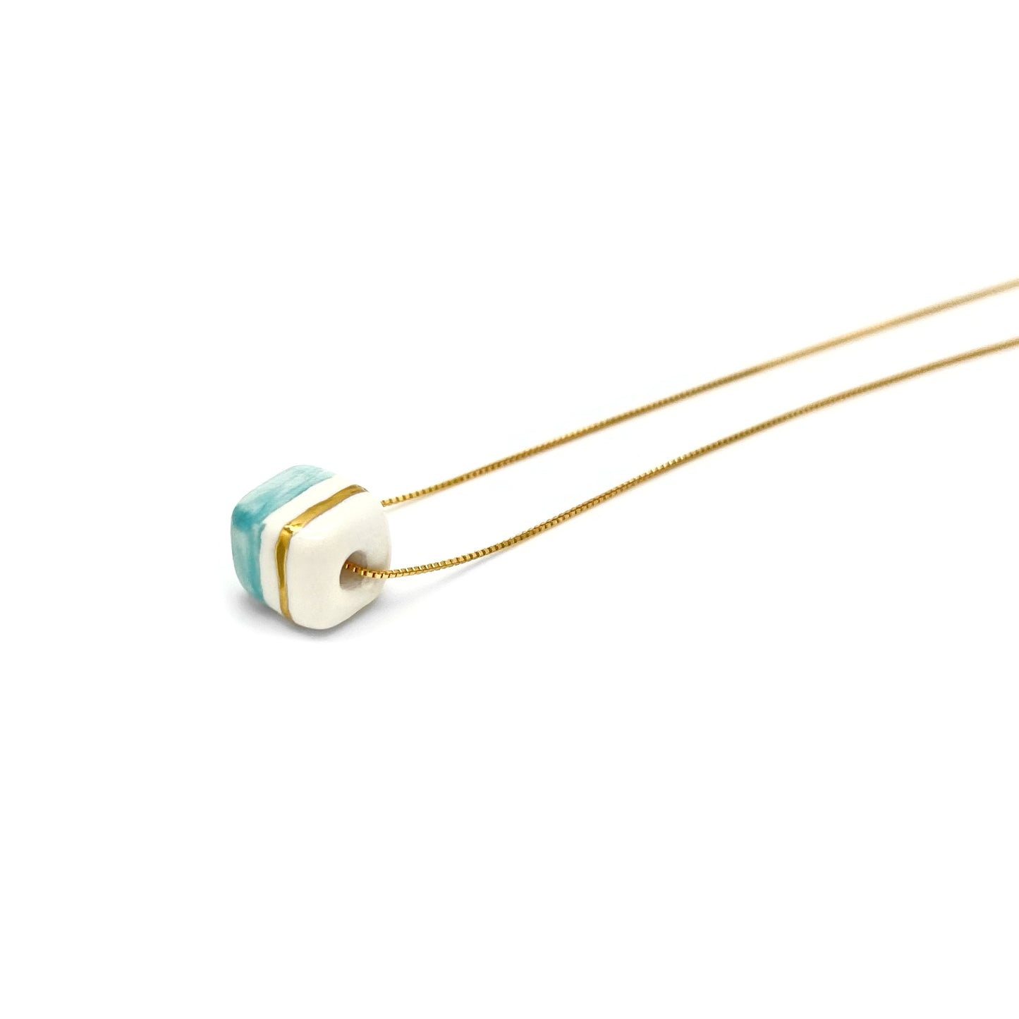 Pendant with cube. Tile print in blue and gold