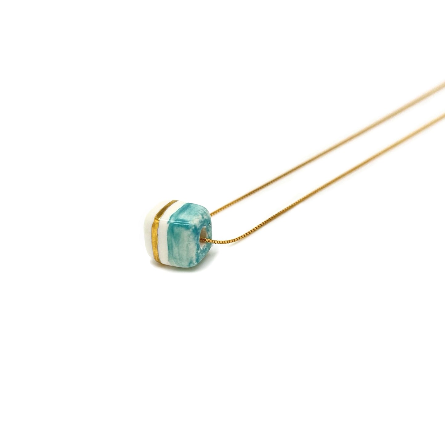Pendant with cube. Tile print in blue and gold