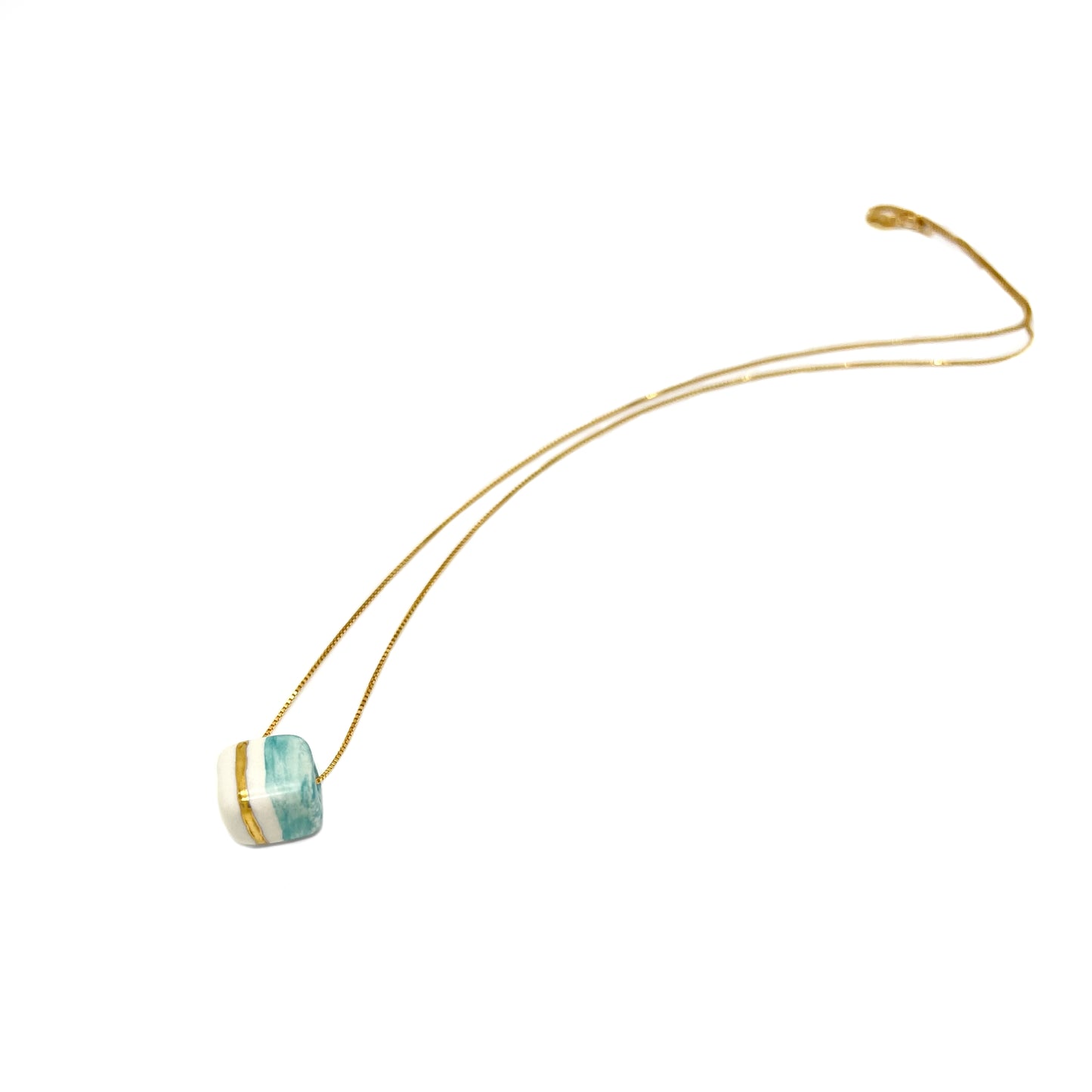 Pendant with cube. Tile print in blue and gold