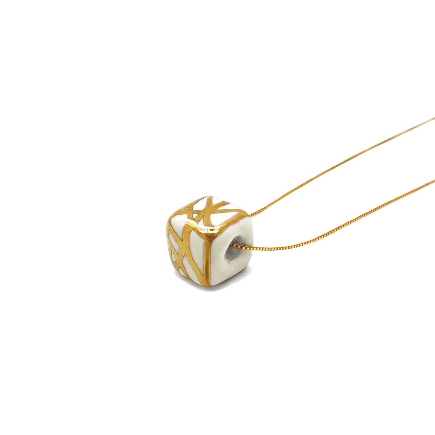 Ceramic pendant with white and gold abstract decoration