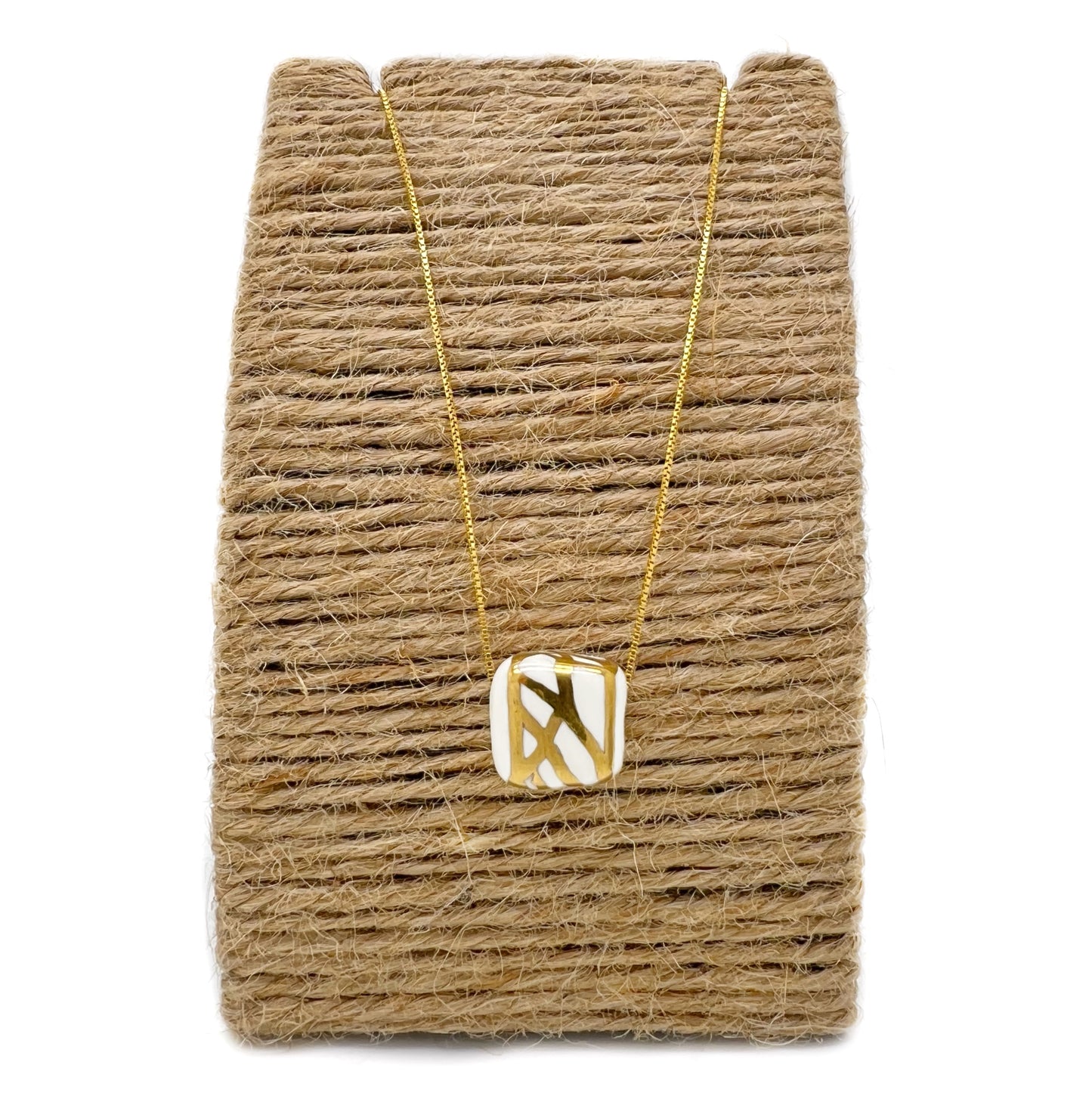 Ceramic pendant with white and gold abstract decoration
